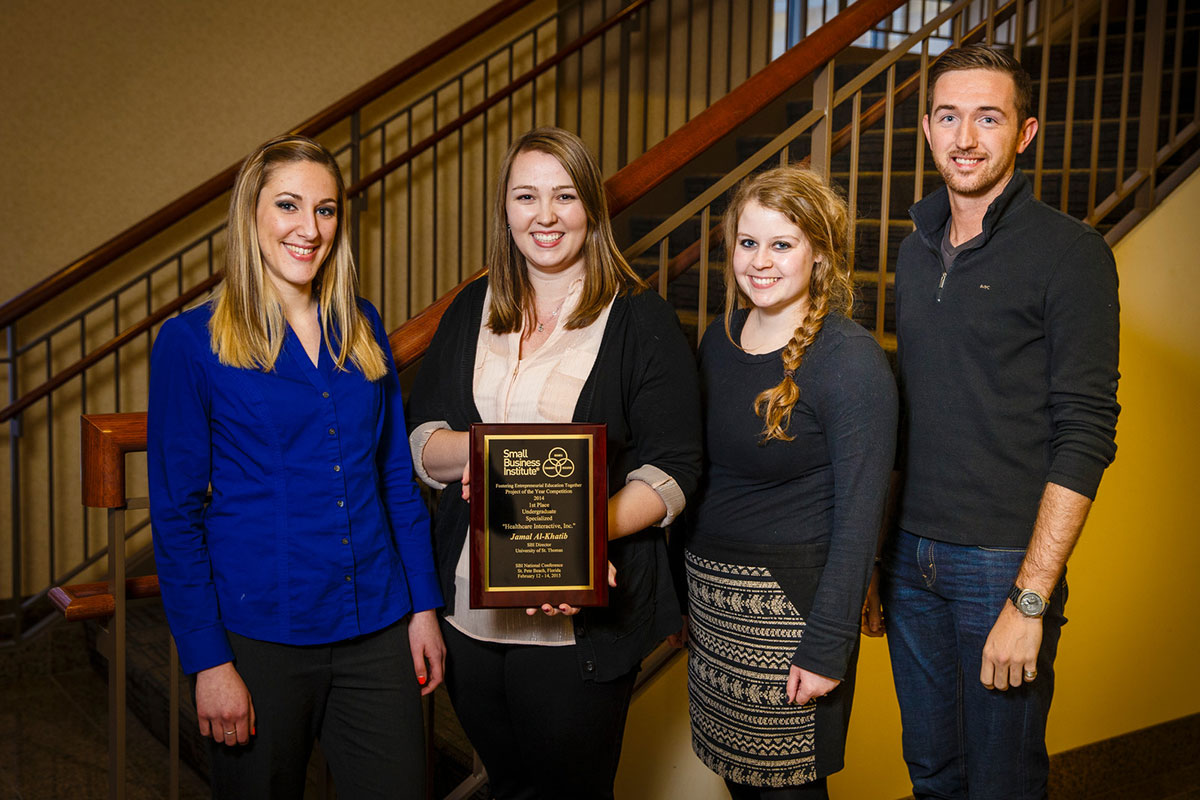 St. Thomas Opus College of Business undergraduate students pose with their first place plaque from the national Small Business Institute competition February 23, 2015 in McNeely Hall.