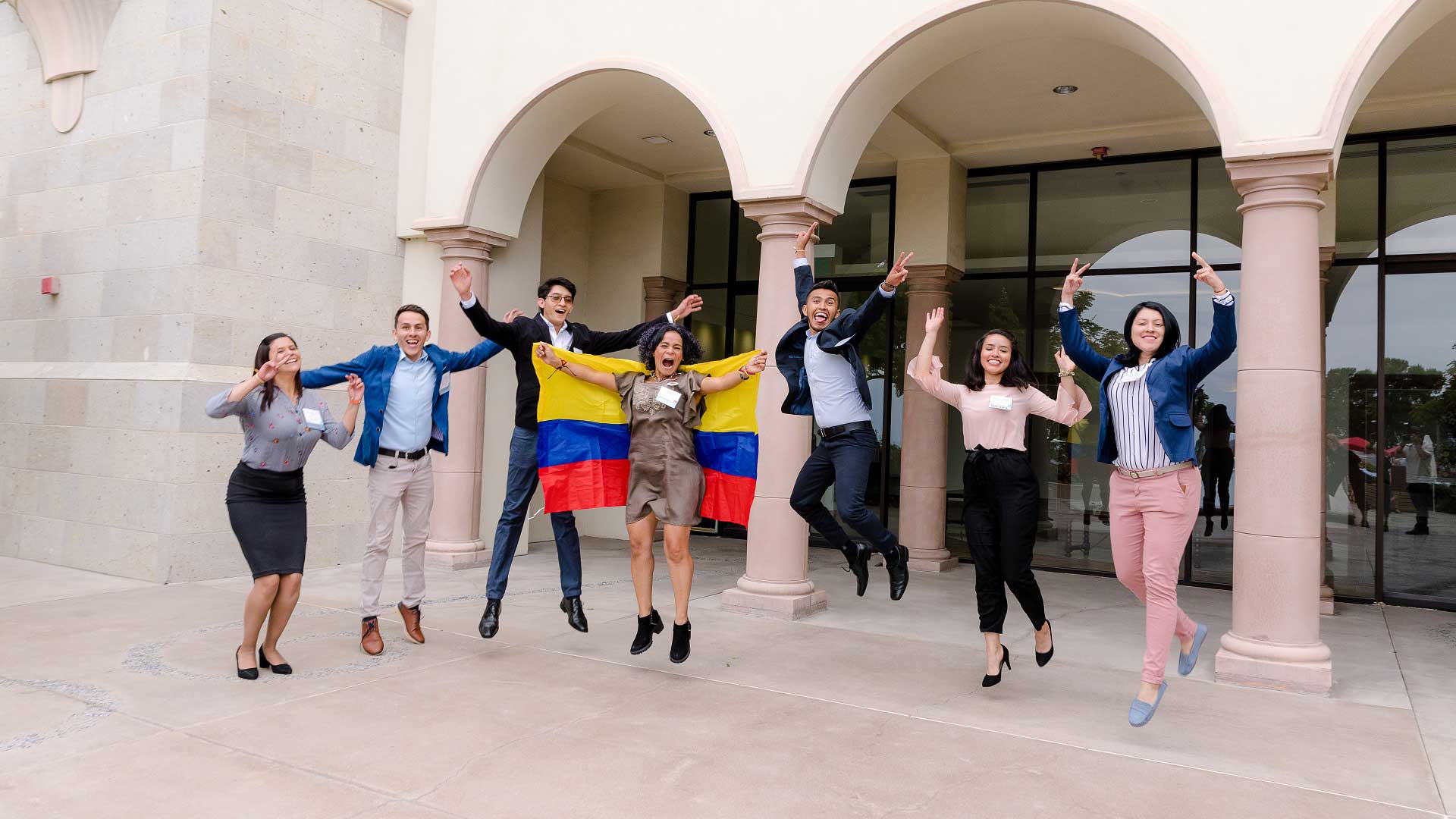 Seven students jump for joy at the Fowler Global Social Innovation Challenge.