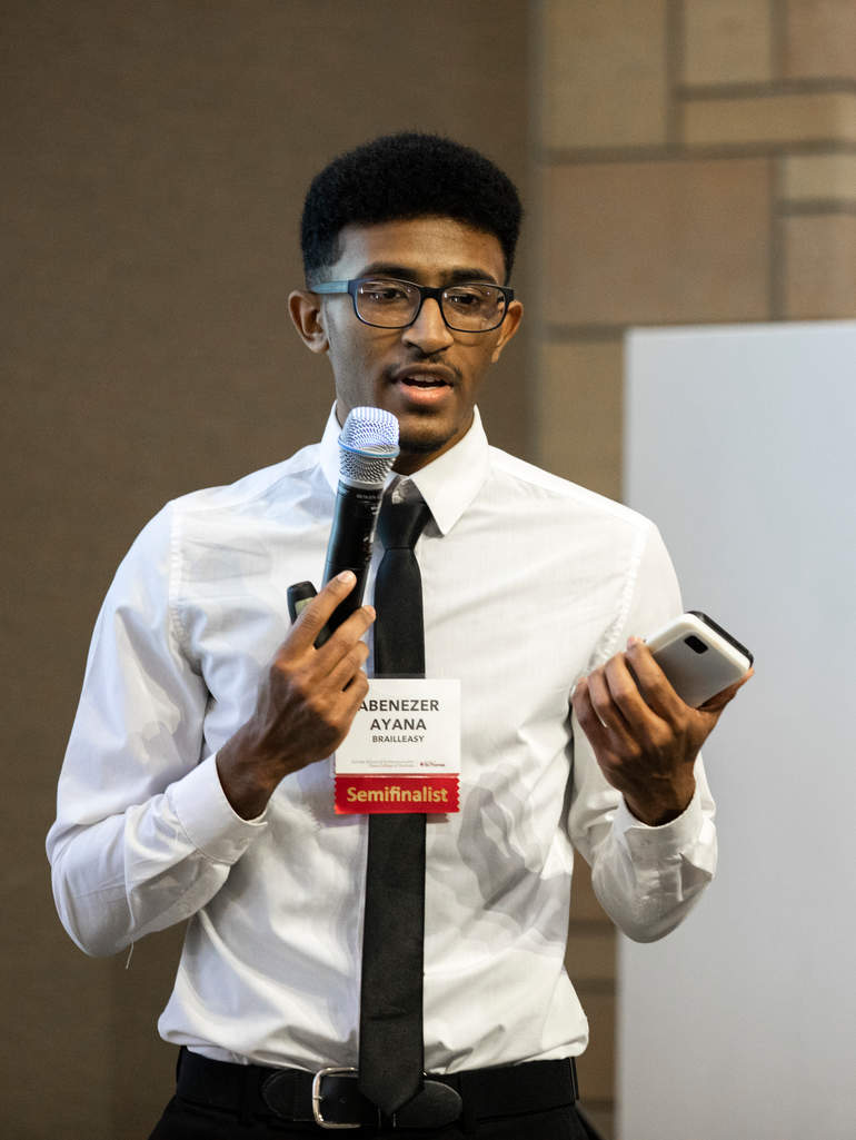 college students holds a microphone and a smartphone