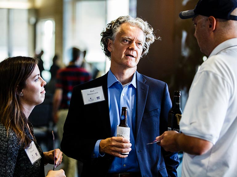 Guests, including Rick Brimacomb, converse outside the Anderson Student Center's Woulfe Alumni Hall before a speech by Opus Distinguished Guy Kawasaki.