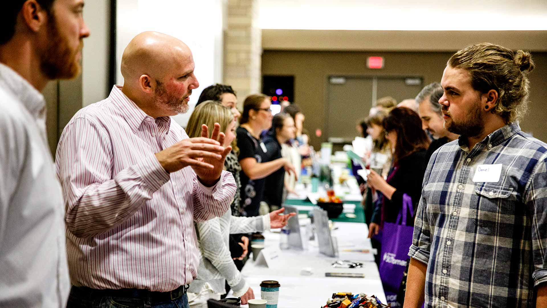 Student talking to a professional at University of St. Thomas event