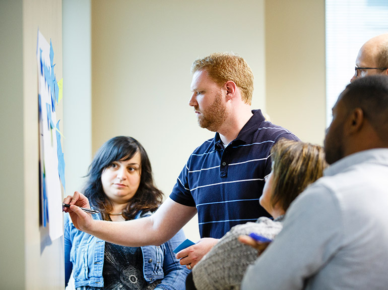 Students work on a group project during an Operations for Executives class in the Executive MBA program.