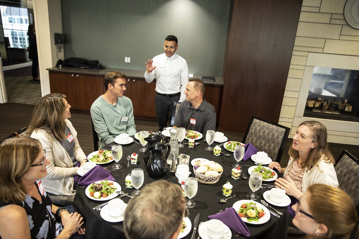 GHR Fellows Program Director Brad Pulles speaks with Fellows and their parents at a dinner.