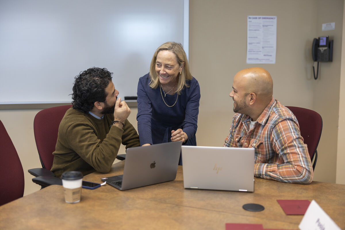 Executive MBA students discussing a topic with faculty