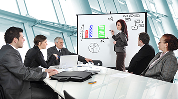 Group of business men and women discussing during a meeting.