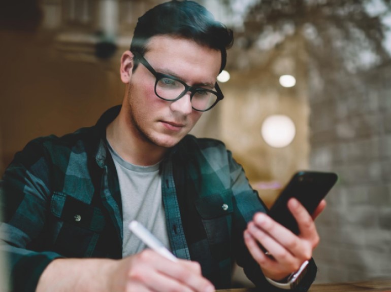 Student looking at his phone.