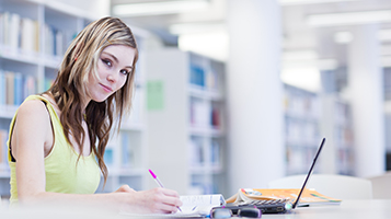 Business student studying in the library.