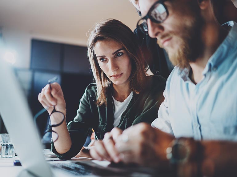 Business man and woman using a computer.