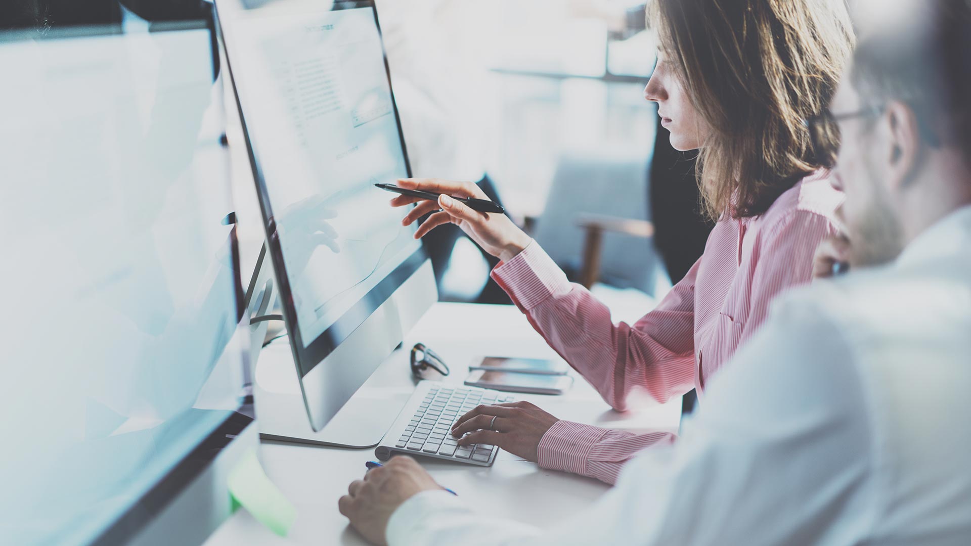 Two graduate business students using a computer