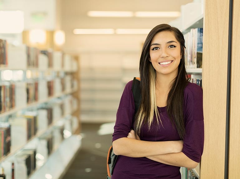 Business student leaning against the wall.