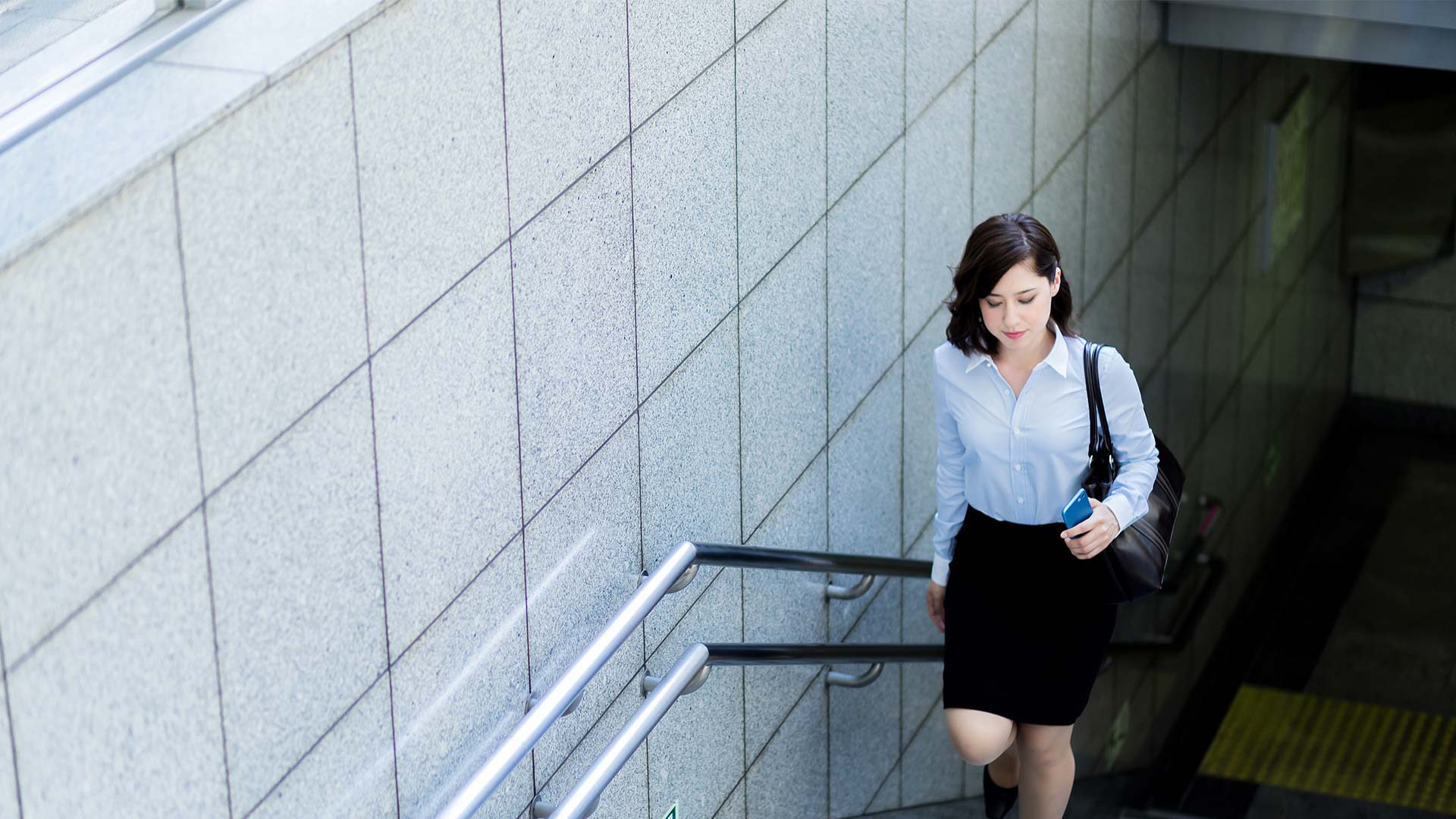 Business woman going up the stairs.