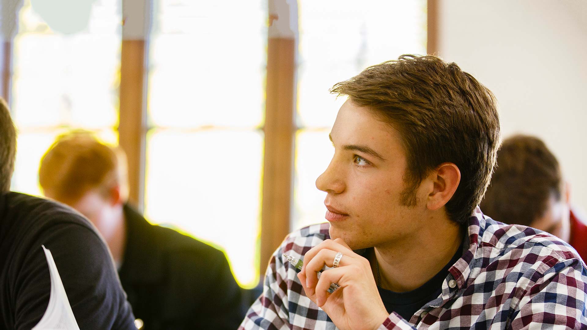 A St. Thomas student listening to a lecture during class