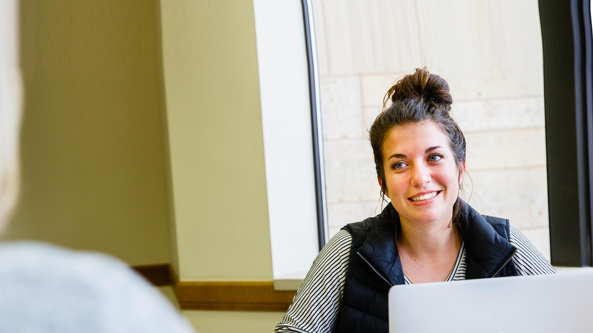 Students study and laugh together during a staged scene in O'Shaughnessy-Frey Library.