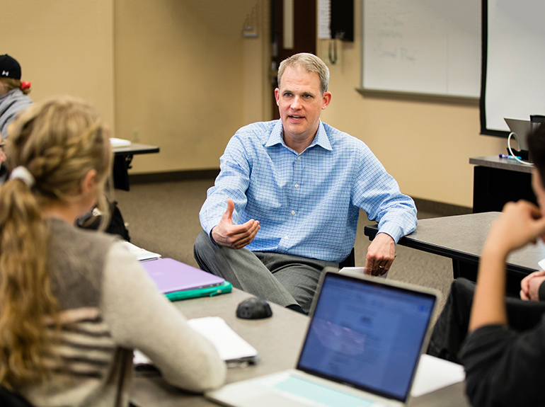 Professor chats with students