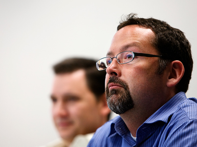 An Opus College of Business graduate student listens to a lecture in a Terrence Murphy Hall classroom.