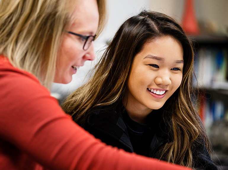 Student and staff smiling