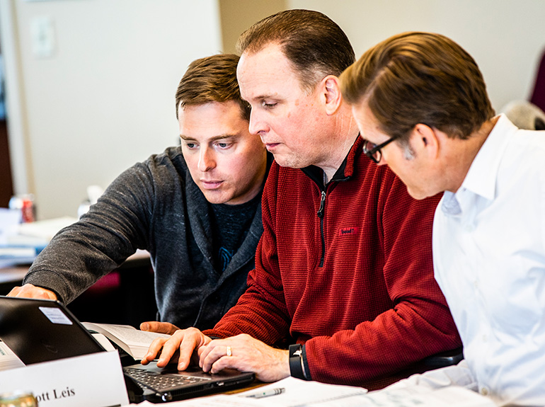 Students work on a group project during a business class in Schulze Hall.
