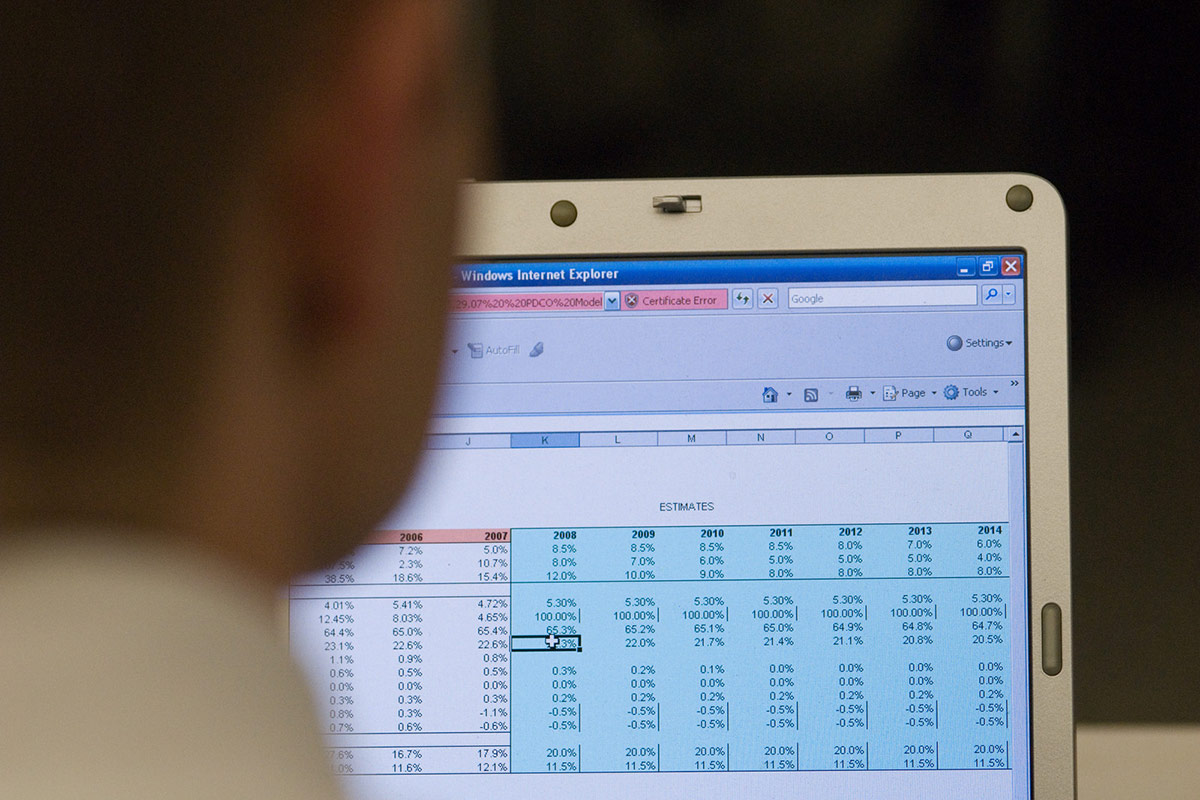 University of St. Thomas student working on a spreadsheet on a laptop.