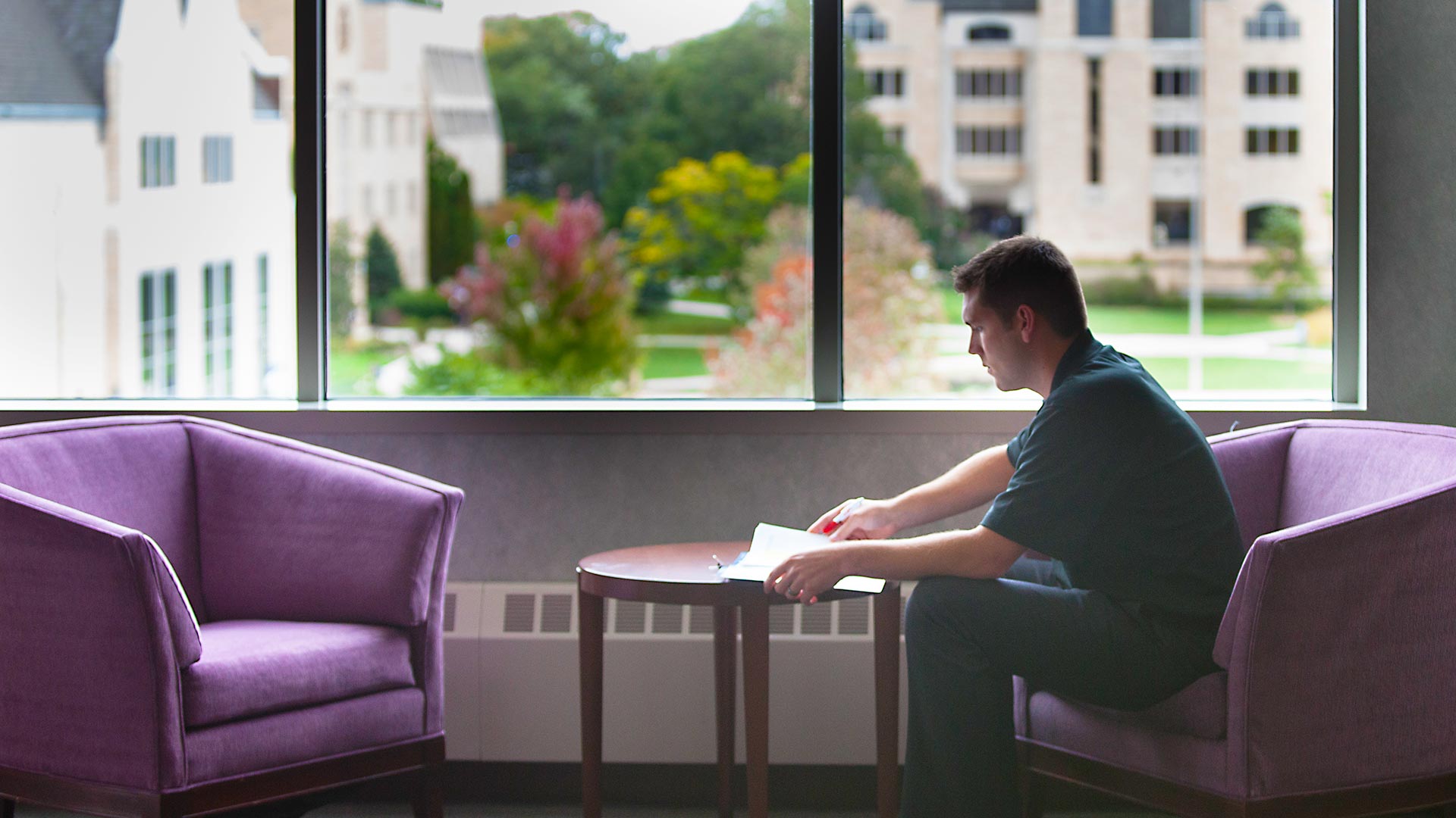 A student sitting and reviewing notes.