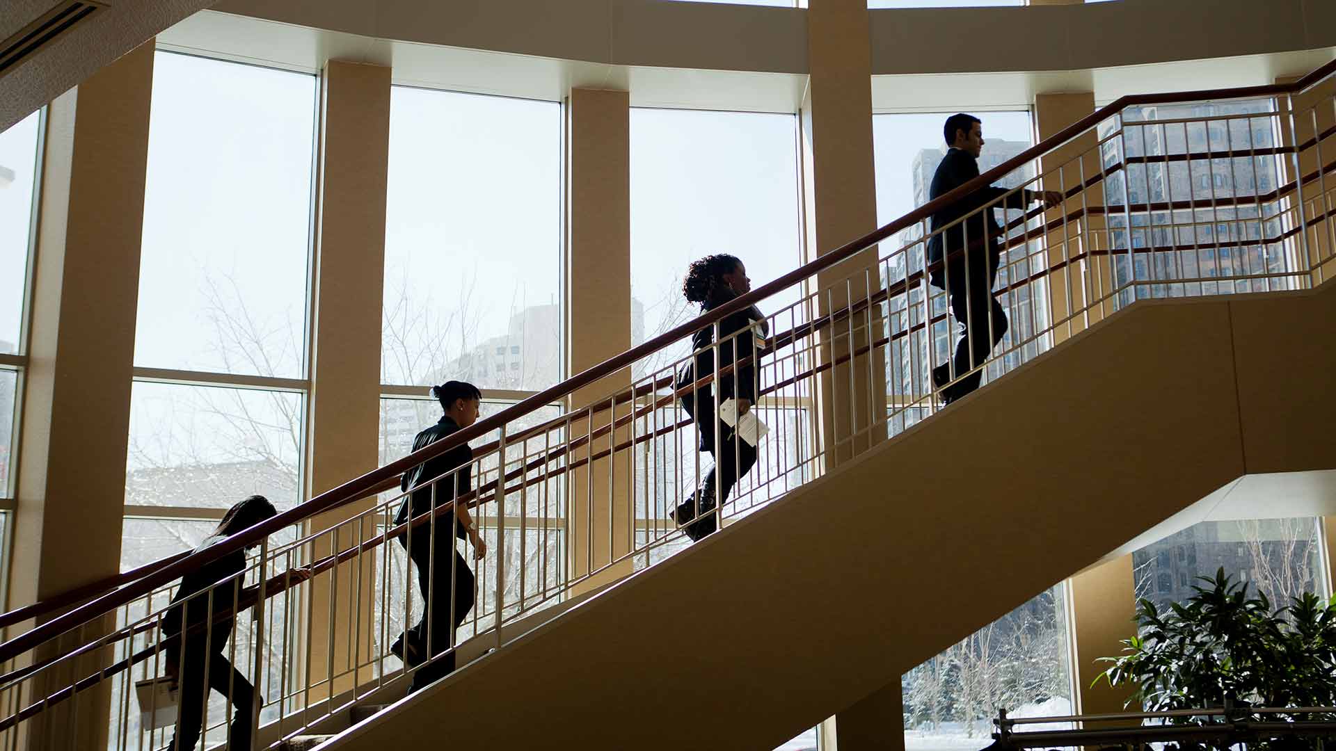 Event attendees head to the second floor of Schulze Hall for a Leadership Summit. 