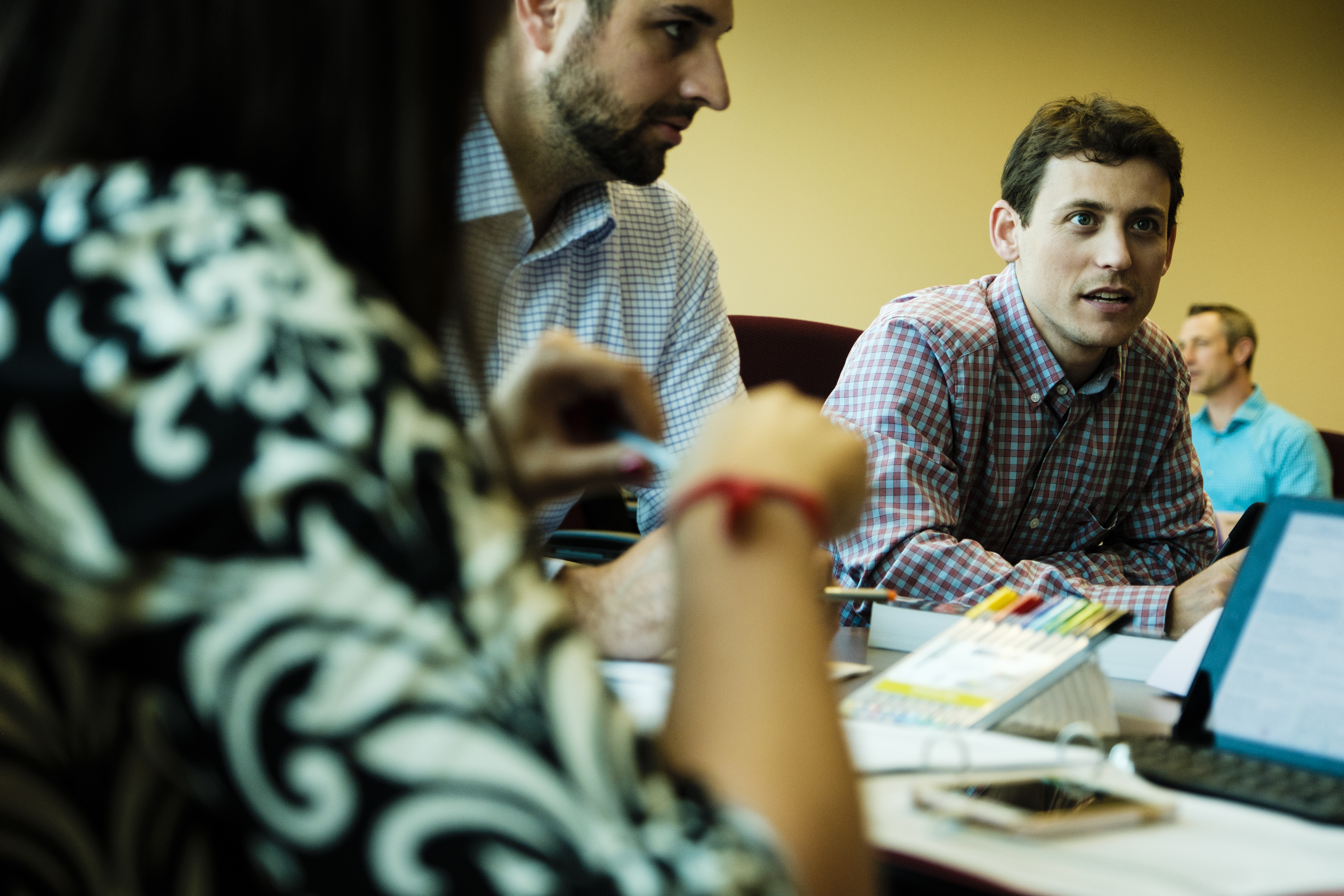 Opus College of Business students discuss a topic during a class in Schulze Hall.
