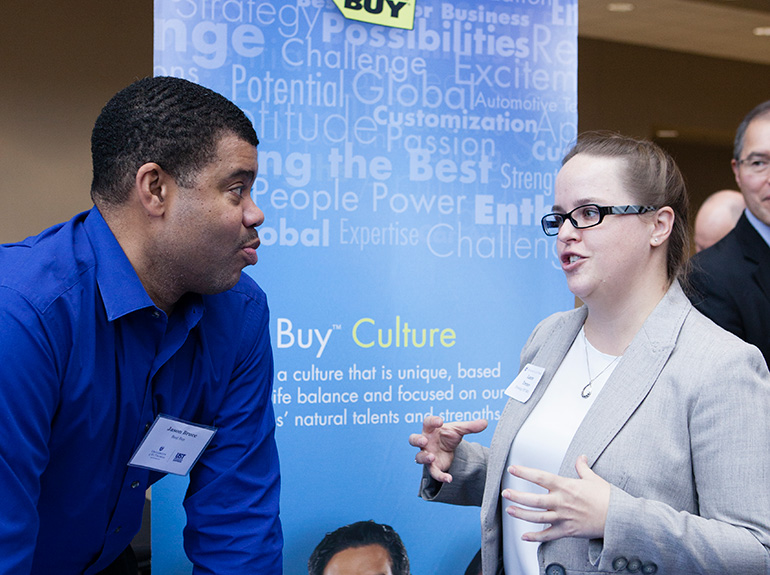 Employers interact with students and alumni at a University of St. Thomas career fair.