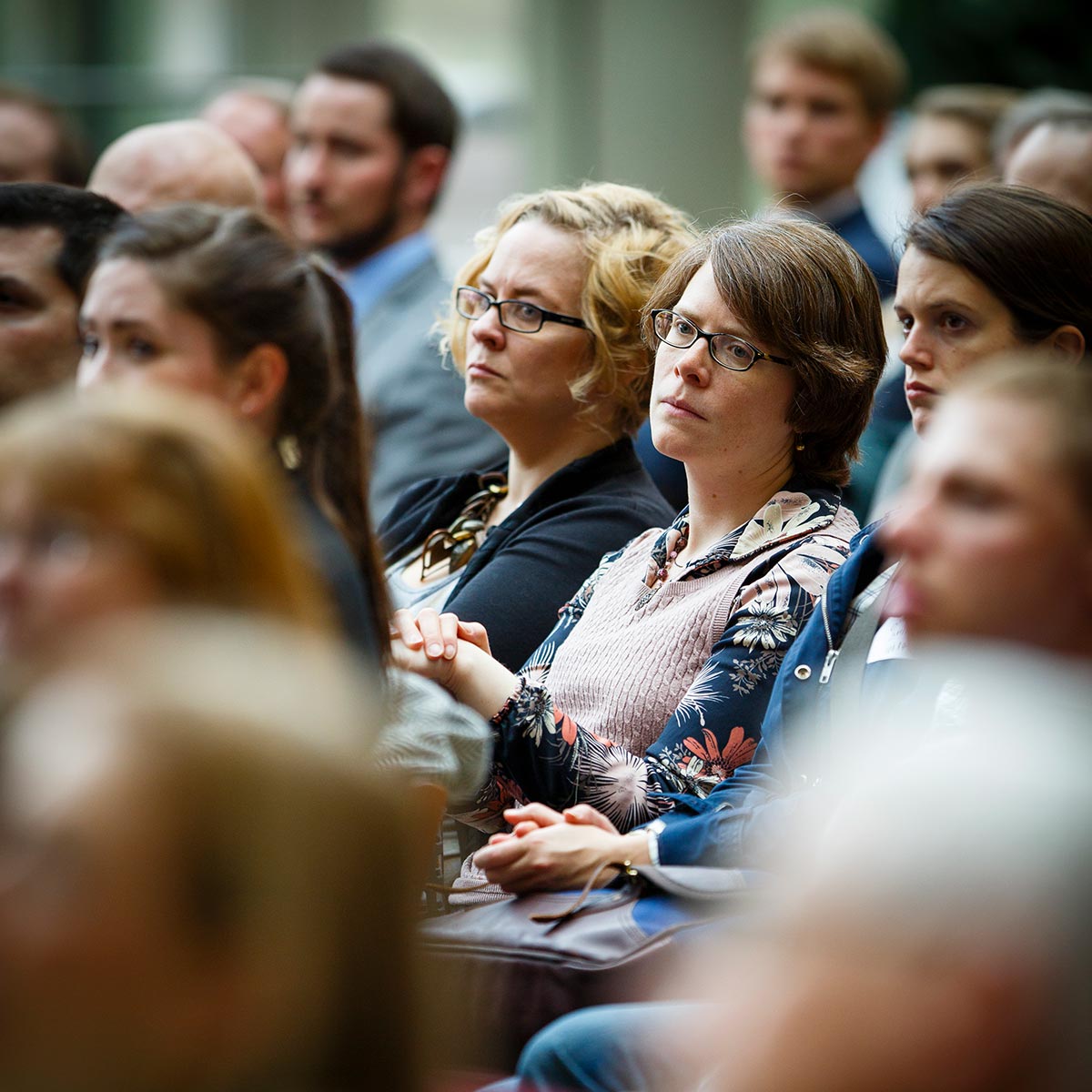 Attendees watch a presentation on the Schulze Grand Atrium.