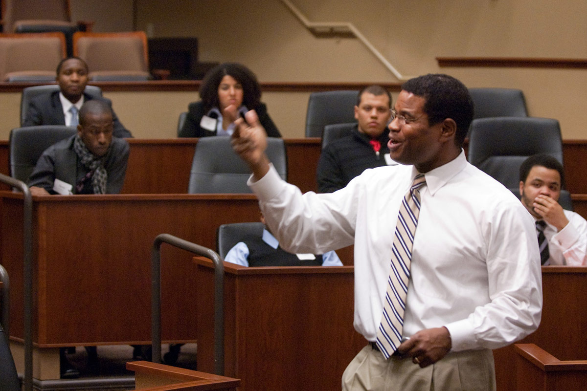 Professor Michael DeVaughn gives an example micro-class to the guests. 