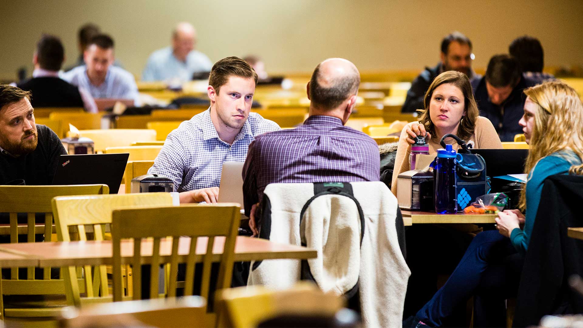A group of students conversing in a cafeteria.