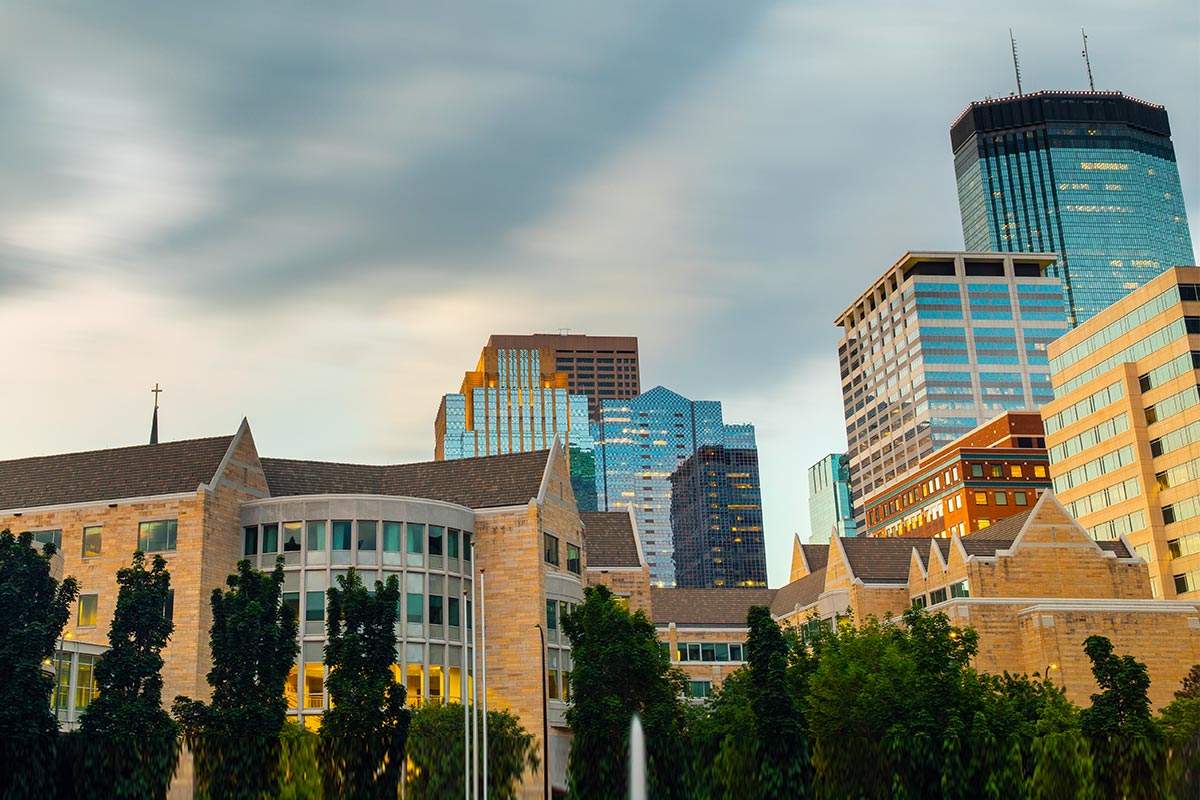 A view of Schulze Hall and the skyline behind in downtown Minneapolis.