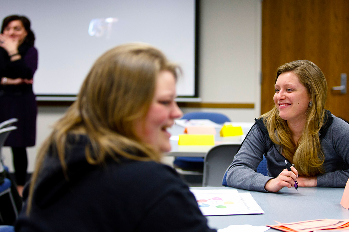 A small class of students work on a group exercise.