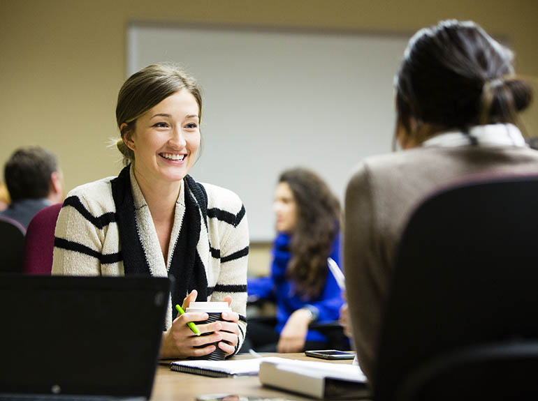 Business woman speaking to a colleague.
