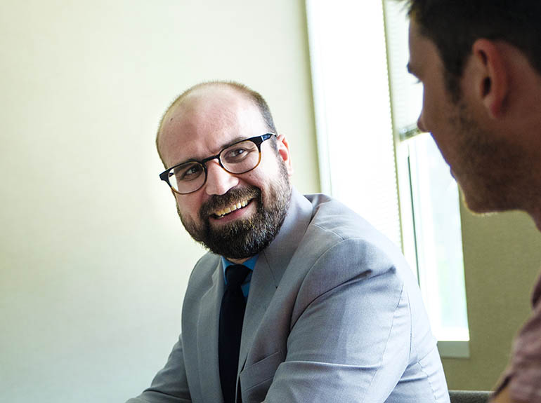 Man engaged in a conversation with a colleague.