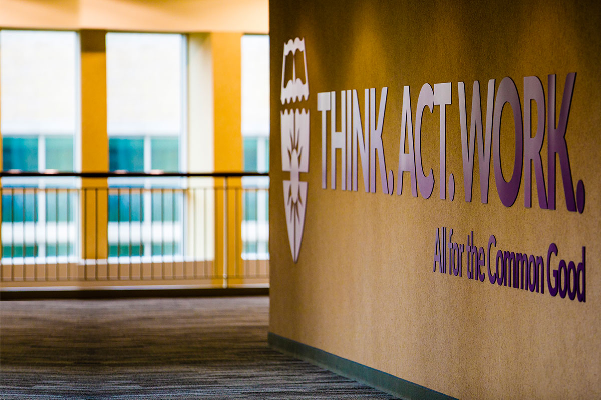 All For the Common Good sign displayed at Opus College of Business in downtown Minneapolis