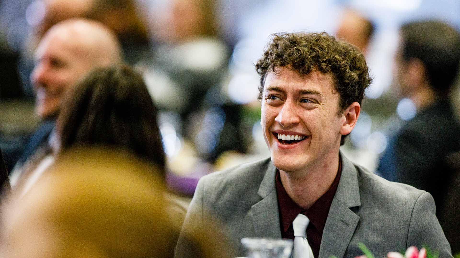 Small BannerGuests laugh at a speech by Mike McAvoy '02, President and CEO of The Onion, during a First Friday event February 2, 2018.