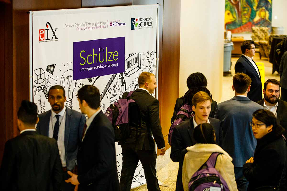 Guests walk past a Schulze Entrepreneurship Challenge sign during the e-Fest