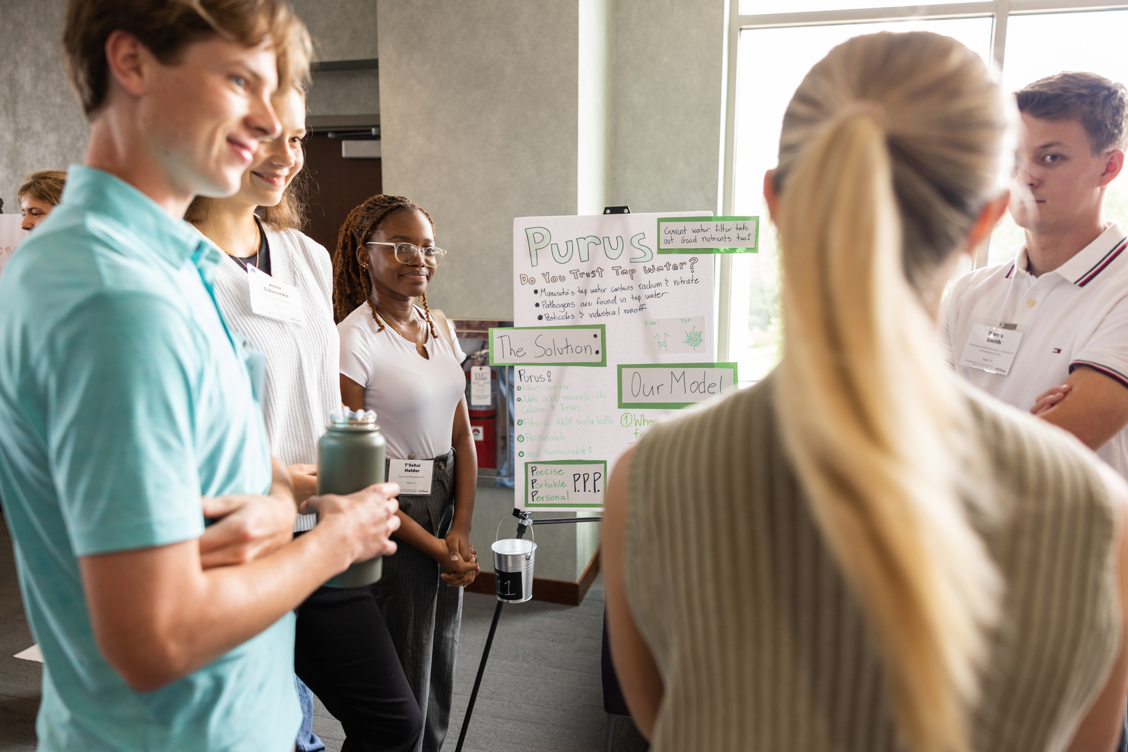 Students practice presenting a business idea and pitch at the Freshman Innovation Day in Woulfe Hall in Fall 2024 in St. Paul.