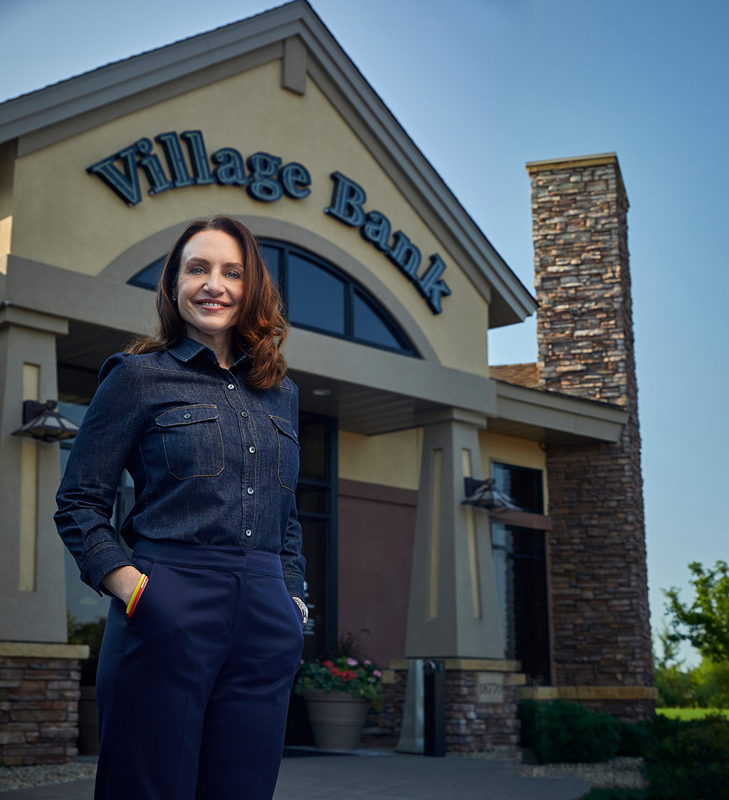 Aleesha Webb stands in front of Village Bank