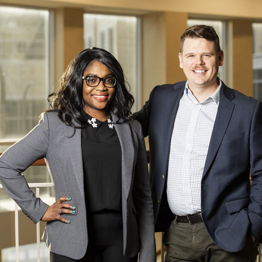 Bukky Durosanya and Luke Dery pose together inside Schulze Hall at the University of St. Thomas.