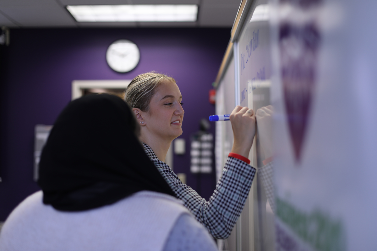 Student writing on whiteboard