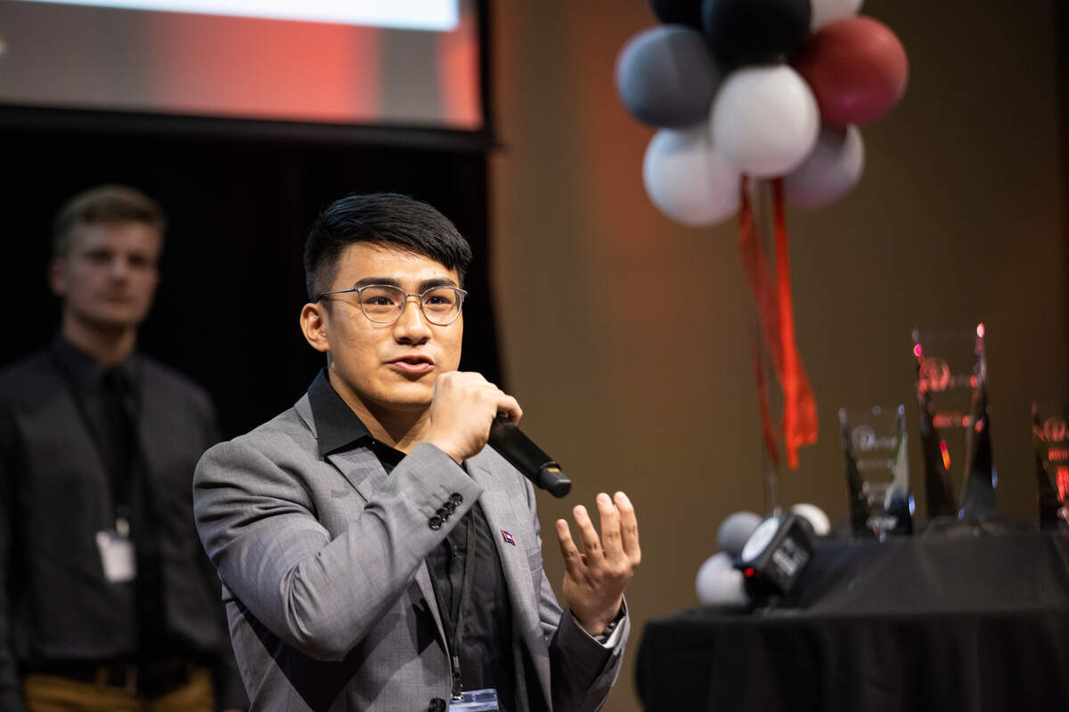 Student holding mic and speaking at e Fest.