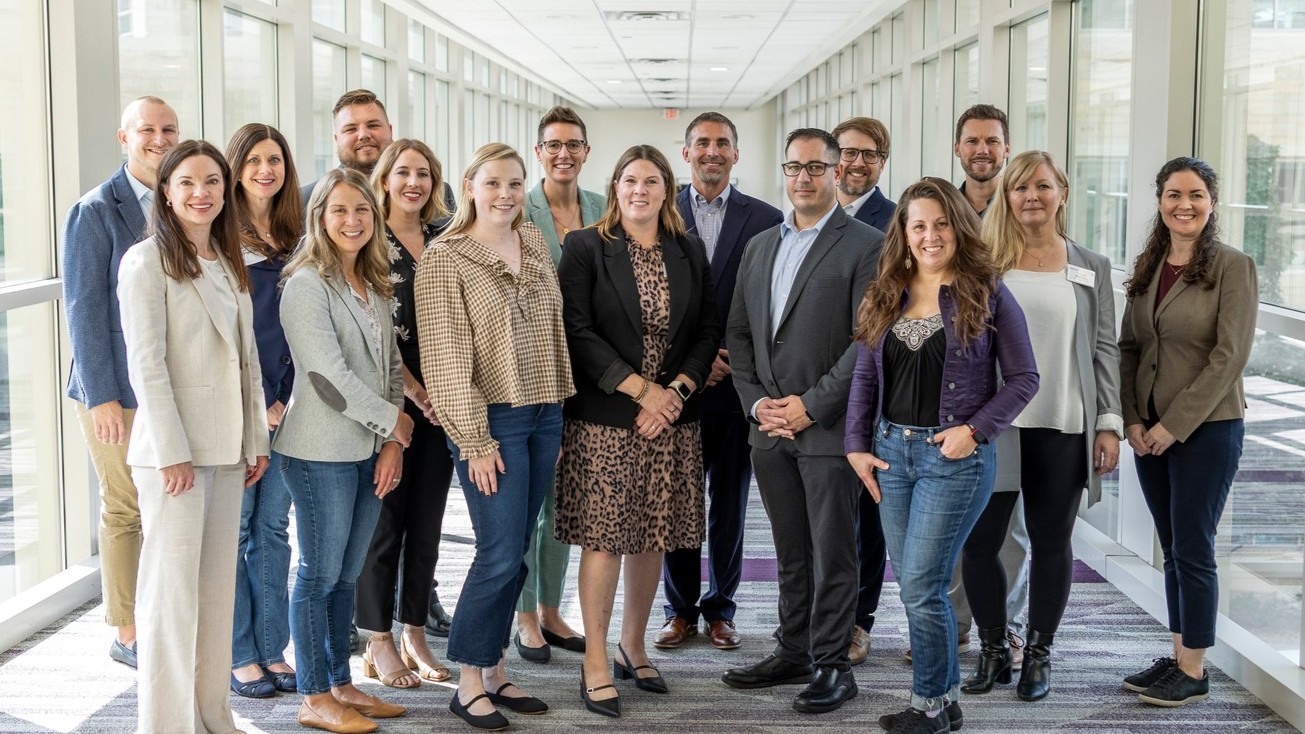Members of the Graduate Business Alumni Board standing posing for a group photo.