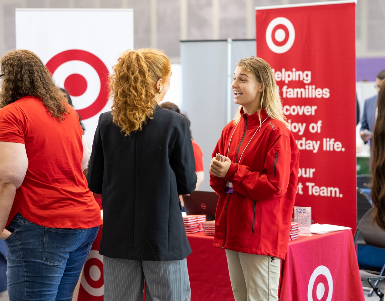 Students engage with employers at the a career fair. 