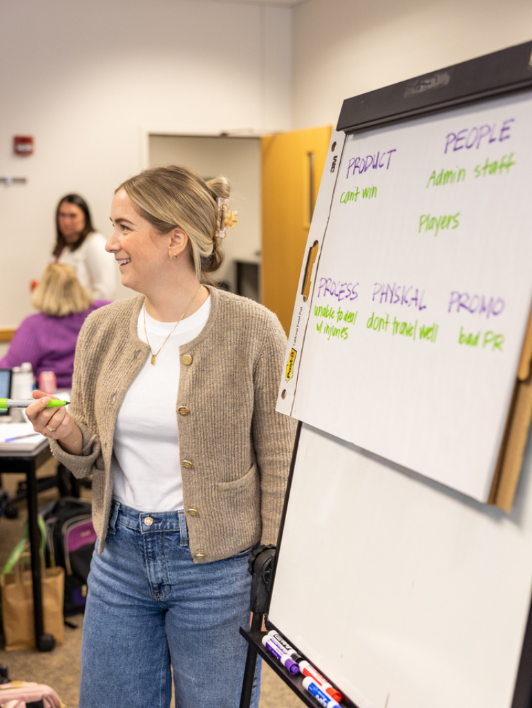 Student standing by a whiteboard