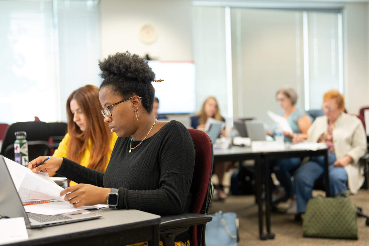 Students attend an Executive Education class in a campus classroom led by faculty Ernest Owens