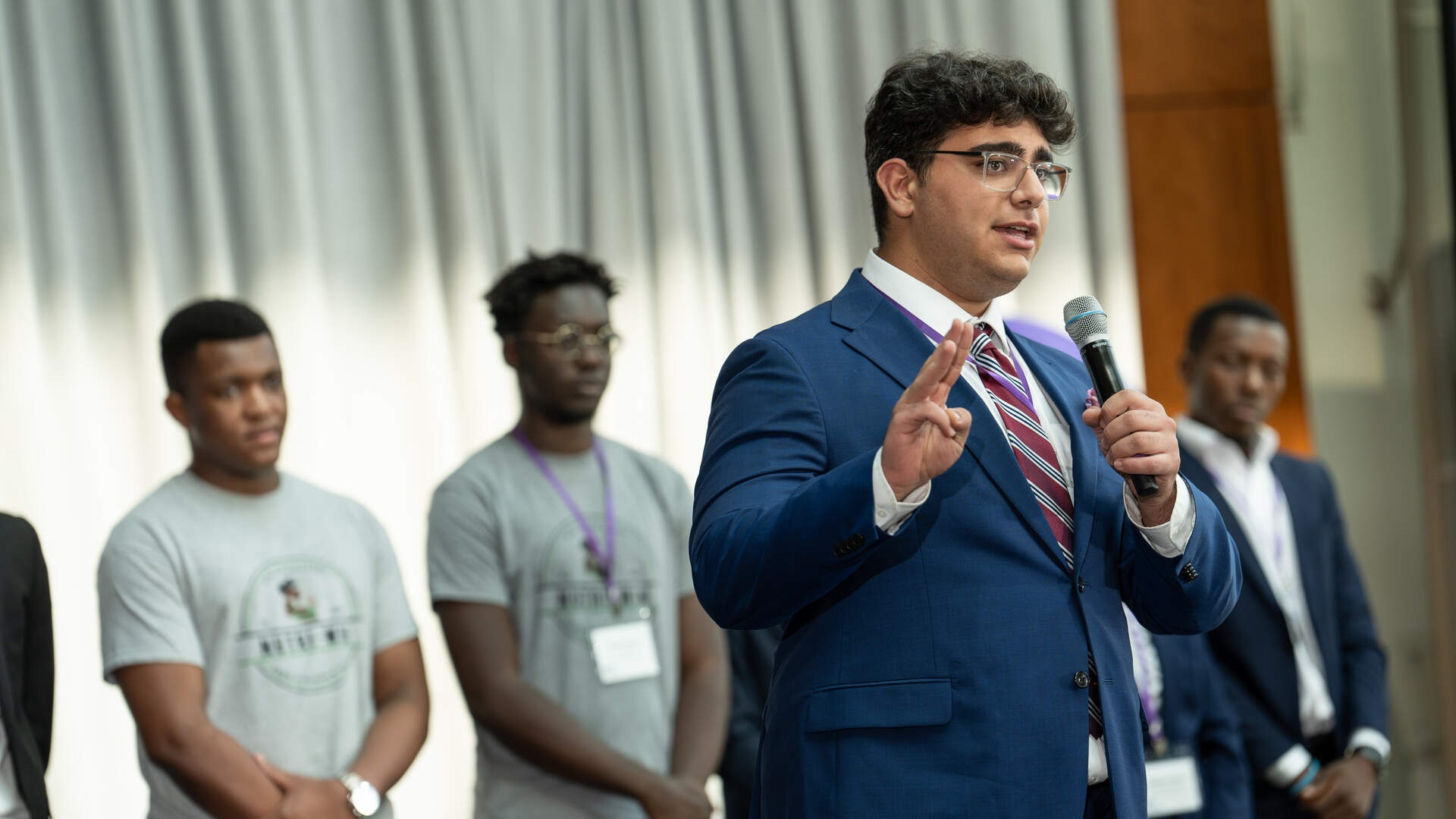 A professor interacts with students.