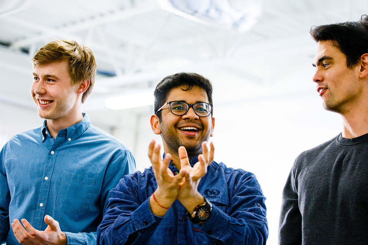 Three students interacting in a focus group.