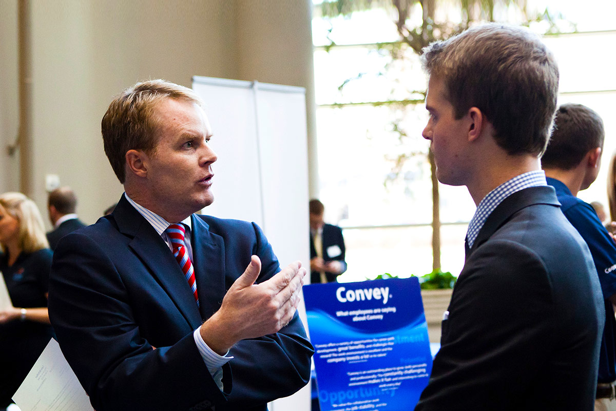 Student engages with a potential employer at a career fair held at Schulze Grand Atrium.